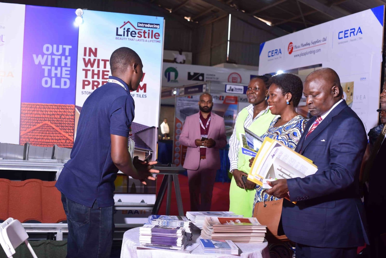 Exhibitor presenting roofing products to visitors at Uganda Buildcon